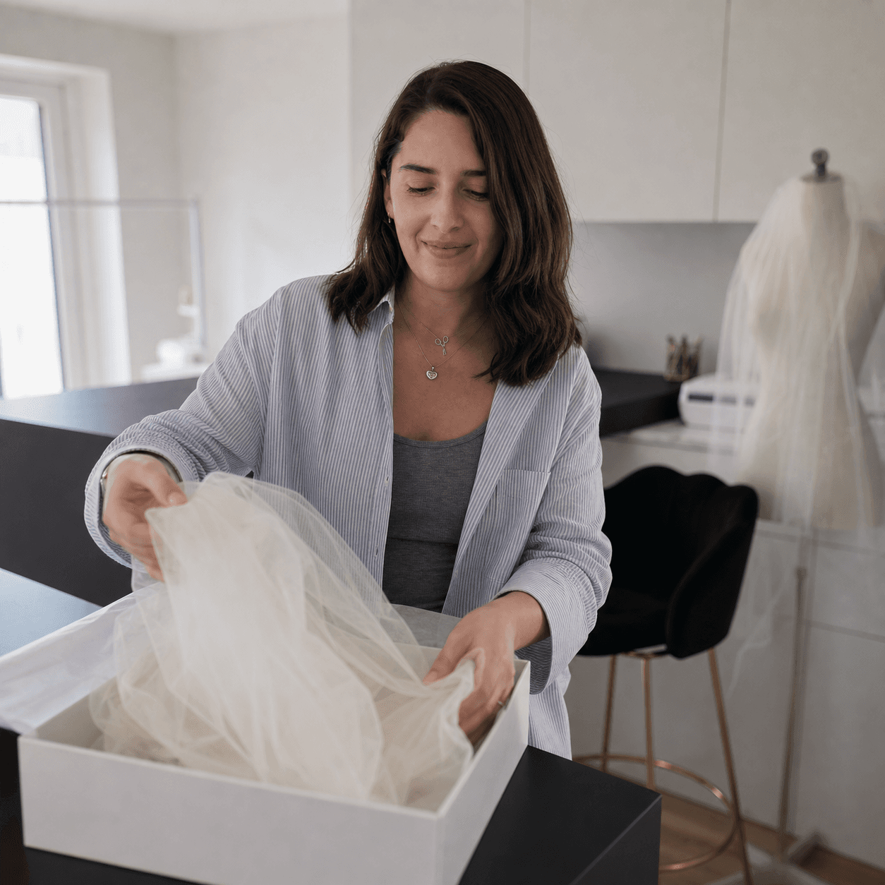 One hand-embroidered veil occupying the atelier worktable